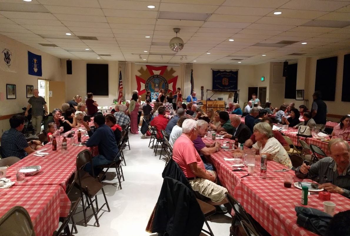 Guests finish eating and wait for the raffle to begin.  